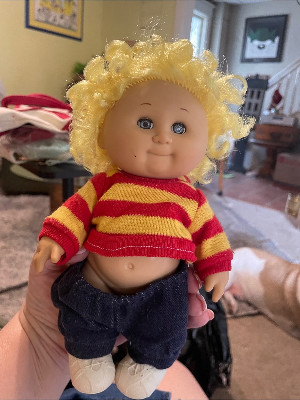 Curly Blonde-Haired Baby Doll with Red & Yellow Striped Sweater